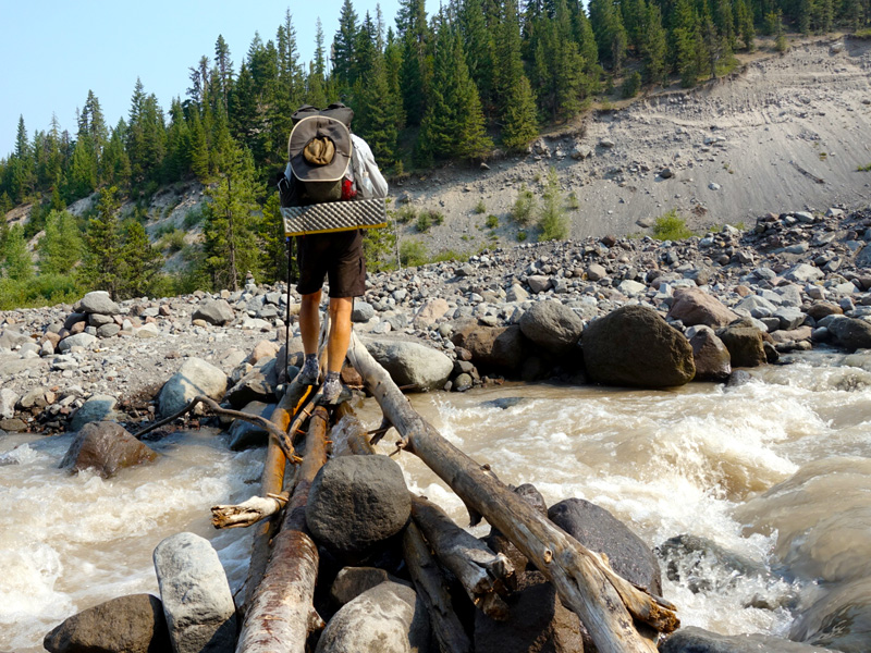 PCT hiker on the precarious Sandy River crossing. Photo by Tami Asars.